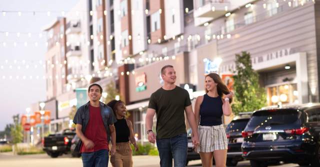 A group of people posing outdoors in Fishers District. Photographer: Amanda Reynolds