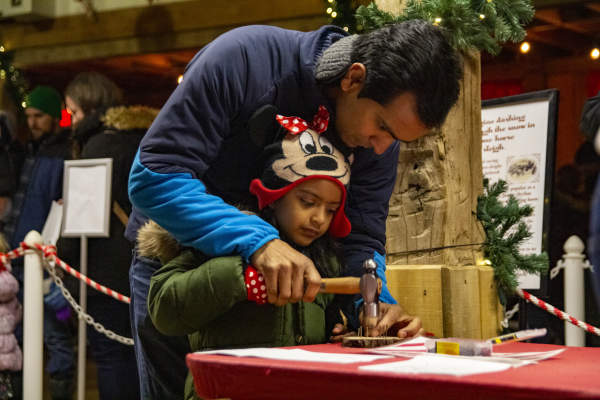 Making crafts at Conner Prairie's A Merry Prairie Holiday.
