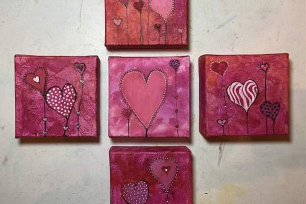 Five small square paintings arranged in a cross pattern, each featuring whimsical heart designs on pink and red backgrounds. The hearts vary in size, patterns, and shades of red and pink, with thin stems extending downward like heart-shaped flowers.