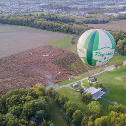 Helium balloon flying over autumn fields during the Headless Horseman festival in Central Indiana.