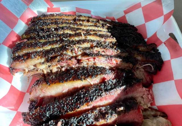 Perfectly cooked brisket with a crispy cust and slight pink middle.