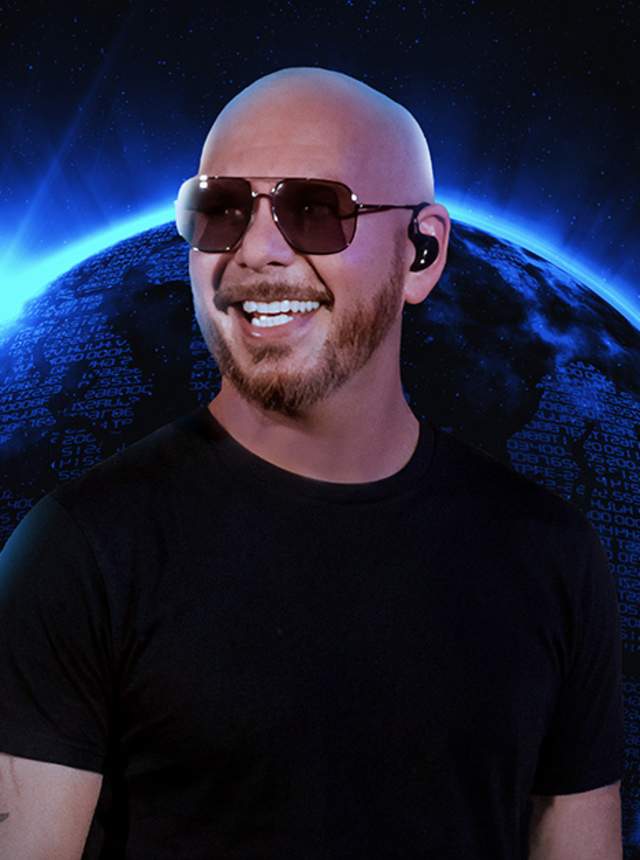 A bald man wearing a black T‑shirt and an in‑ear monitor stands against a glowing blue planet set in outer space, creating a dramatic, futuristic concert-style visual.