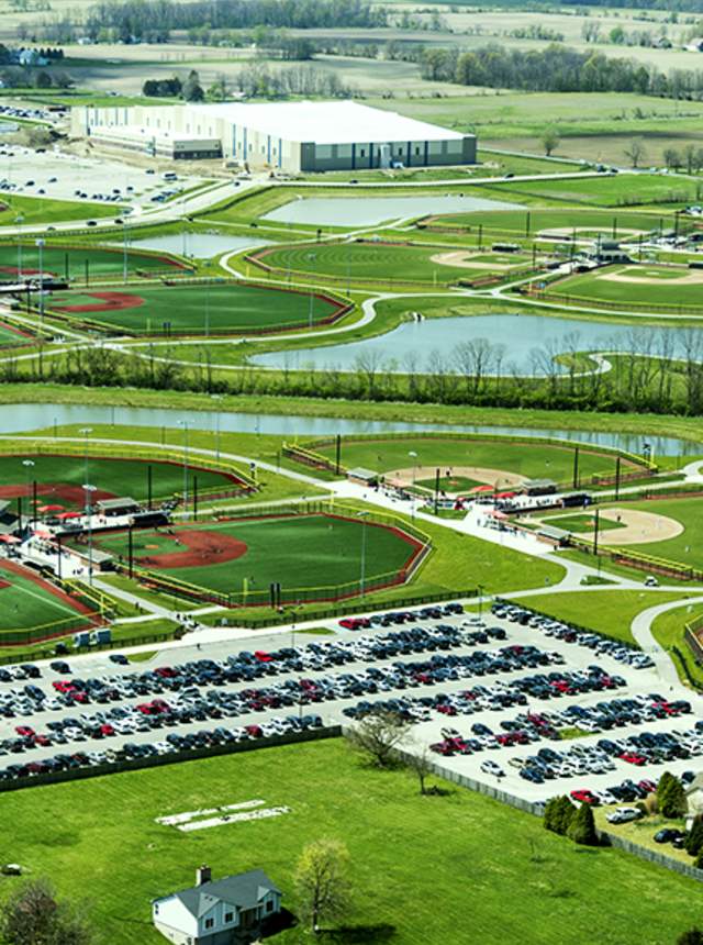 Aerial view of Grand Park in Westfield showing multiple sports fields, parking areas, walking paths, and ponds spread across a large green landscape.