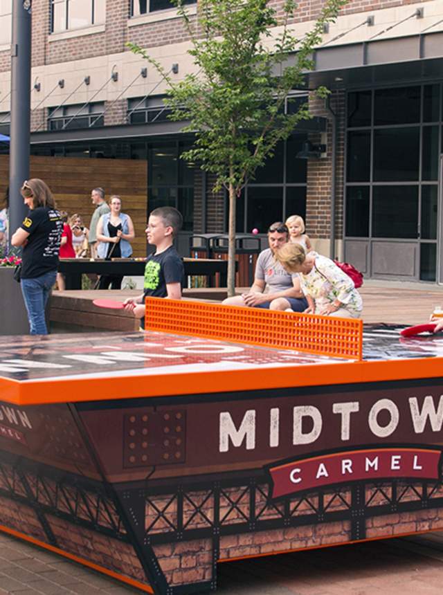 family enjoying a game of ping pong