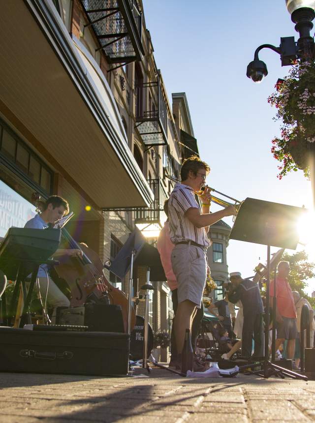 People listening to live music at the Meet Me on Main event in Carmel.