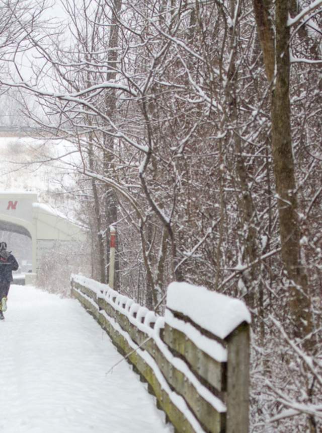 Runner on a snowy path on the Monon Trail