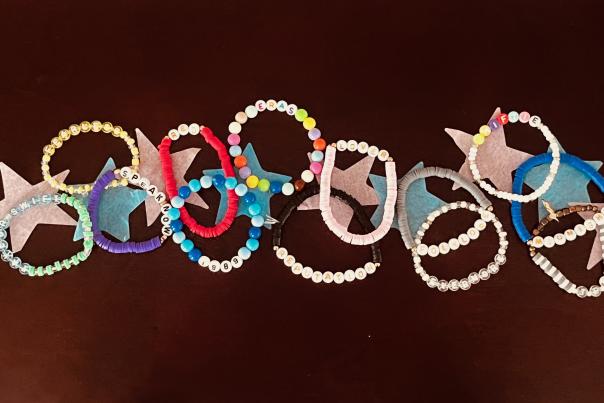 Close-up of several Taylor Swift beaded friendship bracelets with stars.
