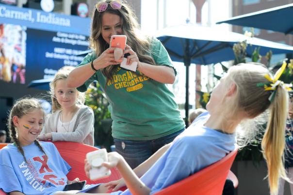 A close-up of a Midwest sports team interacting outdoors and taking a photo.
