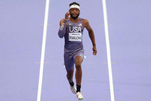 Runner Noah Malone sprinting in a USA uniform.