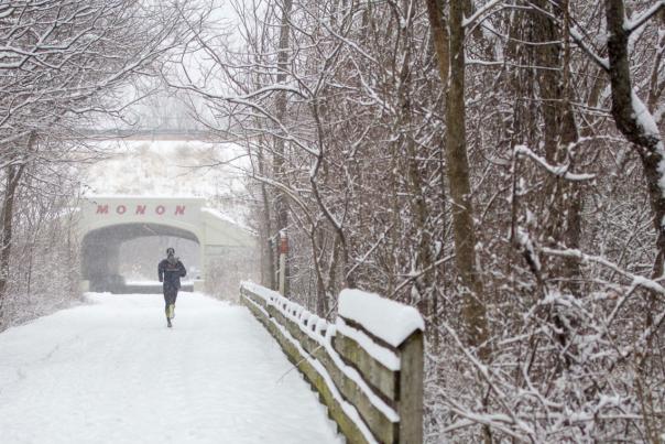 Runner on a snowy path on the Monon Trail