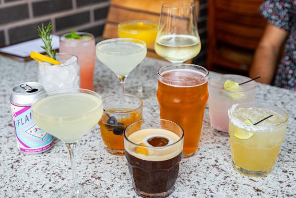A variety of colorful Happy Hour cocktails and drinks at HC Tavern, showcasing vibrant colors and diverse glass styles.