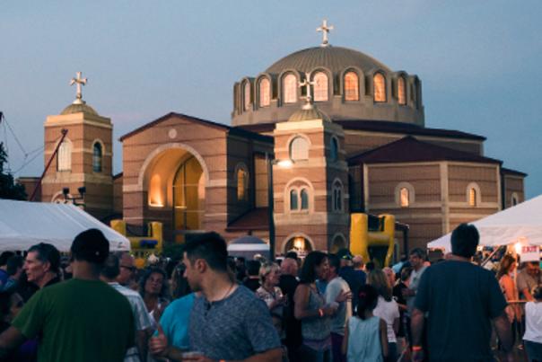 Crowd At Indianapolis Greekfest With An Orthodox Church In The Background