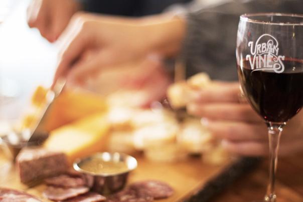 A glass of red wine and a charcuterie board at Urban Vines in Westfield, IN