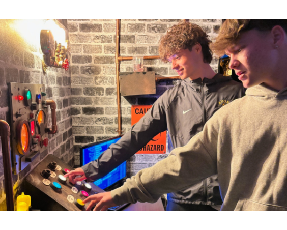 A group tries to solve the puzzle to exit the escape room at Max Missions.