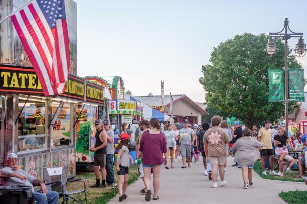 People walk along the busy Hendricks County 4-H Fair Midway