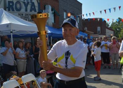 Dick Thompson carrying the torch during the Indiana Bicentennial Torch Relay in 2016.