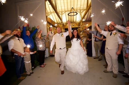 Outside Cartlidge Barn with sparklers after wedding