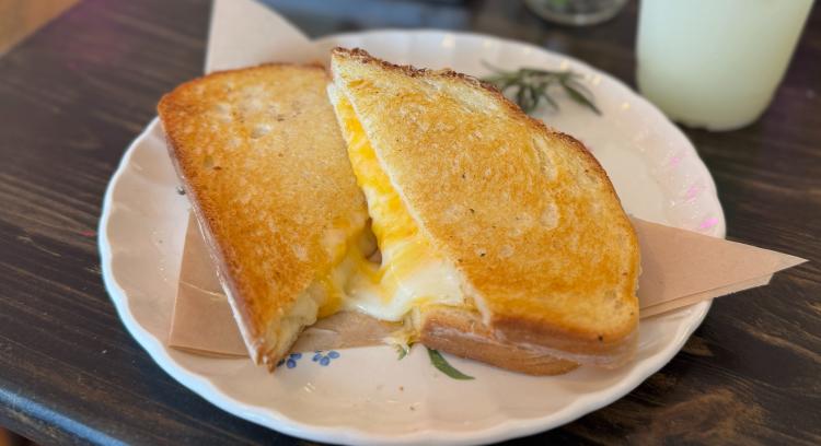 The Danny Toastie at Brie & Bartlett, classic bread and cheese toastie, served on a white plate.
