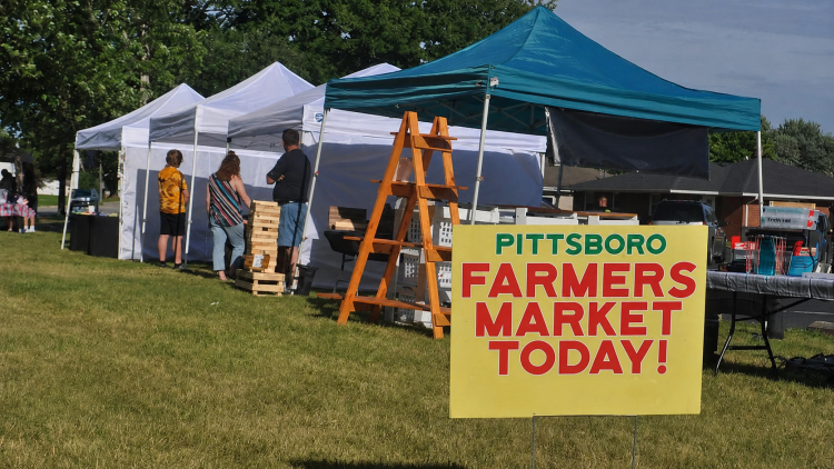 Visitors peruse booths at the Pittsboro Farmers Market