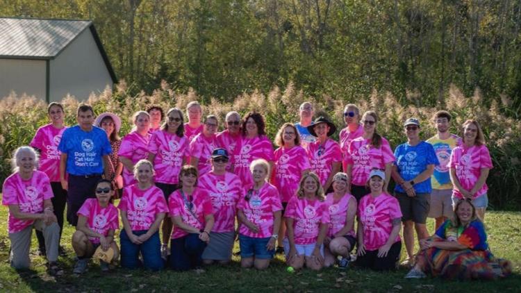 Group of volunteers in pink and blue shirts
