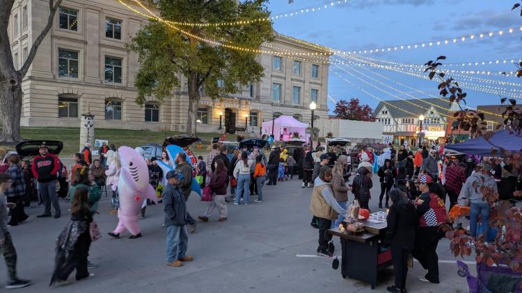 Crowds walking along the Danville square in costume.