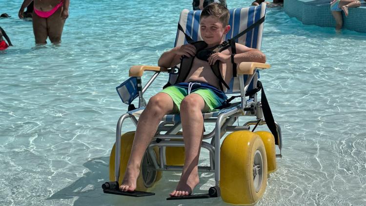 Water wheelchair being used in the pool at Murphy Aquatic Park in Avon, Indiana, allowing a child to enjoy the water.