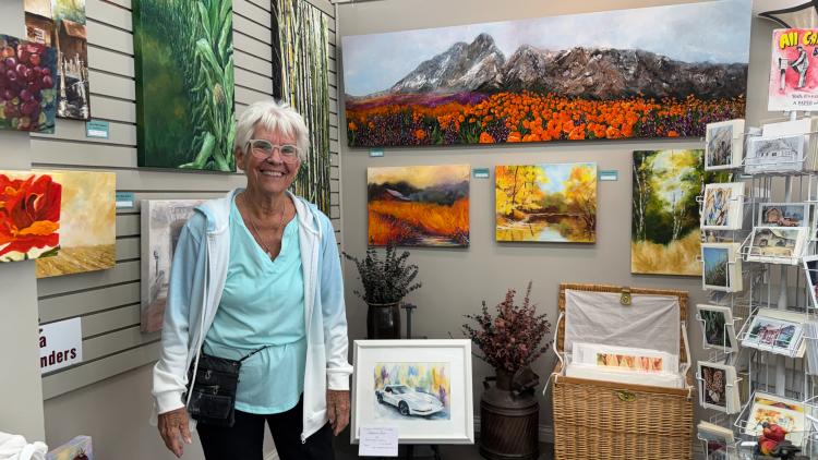 Local artist Donna Nolan-Sanders stands with her artwork at Gallery on the Square in Danville, Indiana.