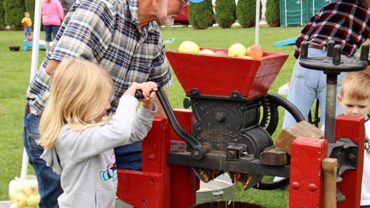 Operate an apple cider press at the Fall Colors Festival. (Photo by Deb Stukenborg)