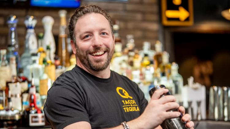Let the bartender serve you up a drink (Photo courtesy of Queso's Plainfield)