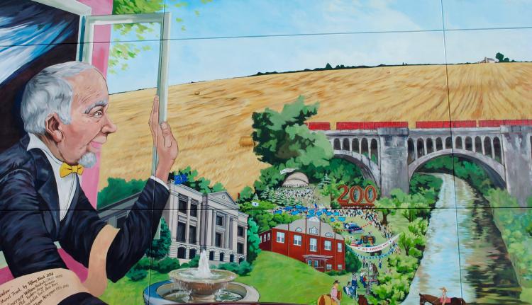 This mural created by Tiffany Black on the side of a building in Danville depicts William Hendricks looking over some of our county's attractions.