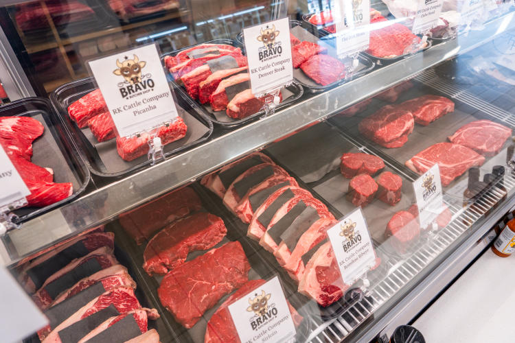 Various red meats inside a case at Roots Market + Eatery in Plainfield, Indiana
