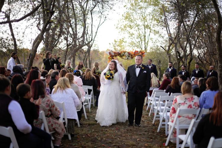 A couple walks down the isle at Martha's Orchard (Laura Leigh Photography).