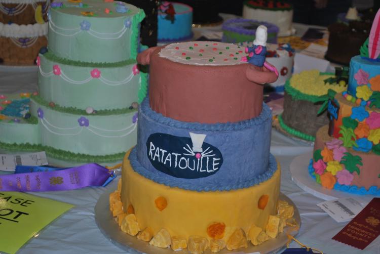 Three-tier yellow, blue and pink cake