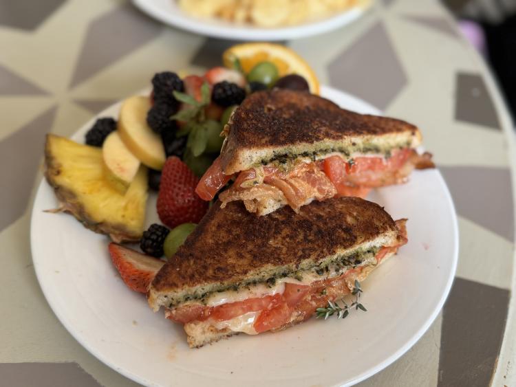 The Summery Grilled Cheese at Bread Basket Cafe & Bakery, served with fresh fruit.