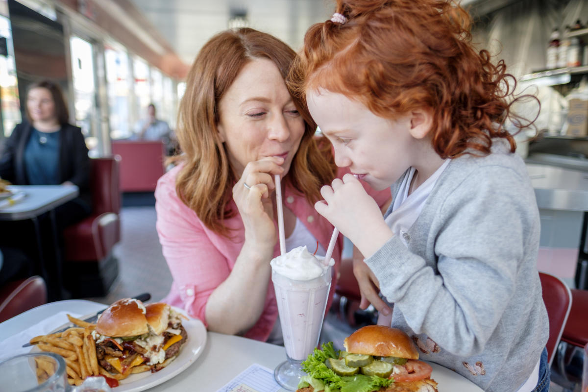 Oasis Diner mother and daughter sipping milkshake