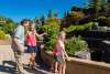 A family of four looks happily at the outdoor train display.