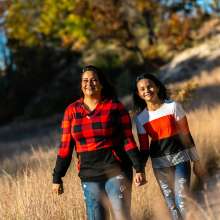 A mother and child hike in the fall.