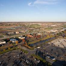 Aerial view of a downtown area with retail shops and parking lots