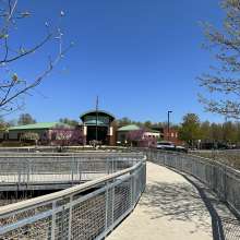 A boardwalk with railings leads up to a building