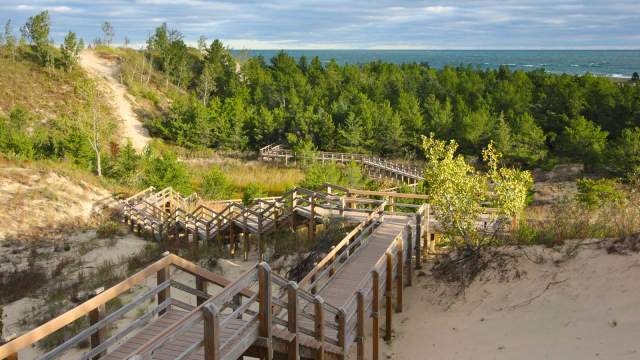A wooden staircase leading down towards the water