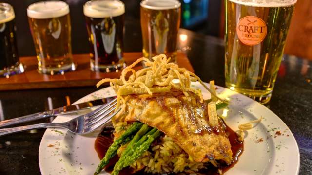 A plate of food with a flight of beer