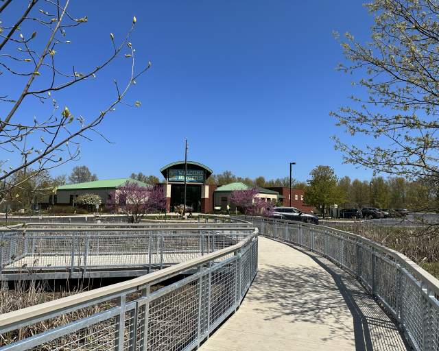 A boardwalk with railings leads up to a building