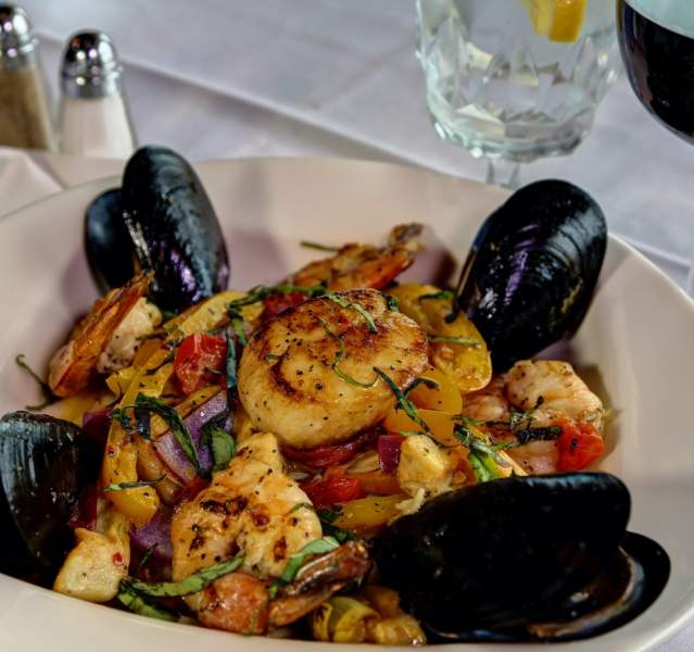Bowl of food with clams and scallops