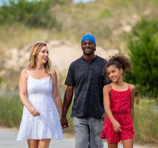 Happy family walking along a path