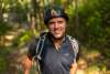 A man in a bike helmet smiles at the camera.