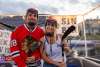 A man and woman are dressed in hockey gear for the picture.
