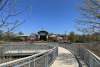 A boardwalk with railings leads up to a building
