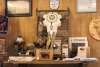 A decorated bison skull hangs on the wall. A table below it holds various bison products.