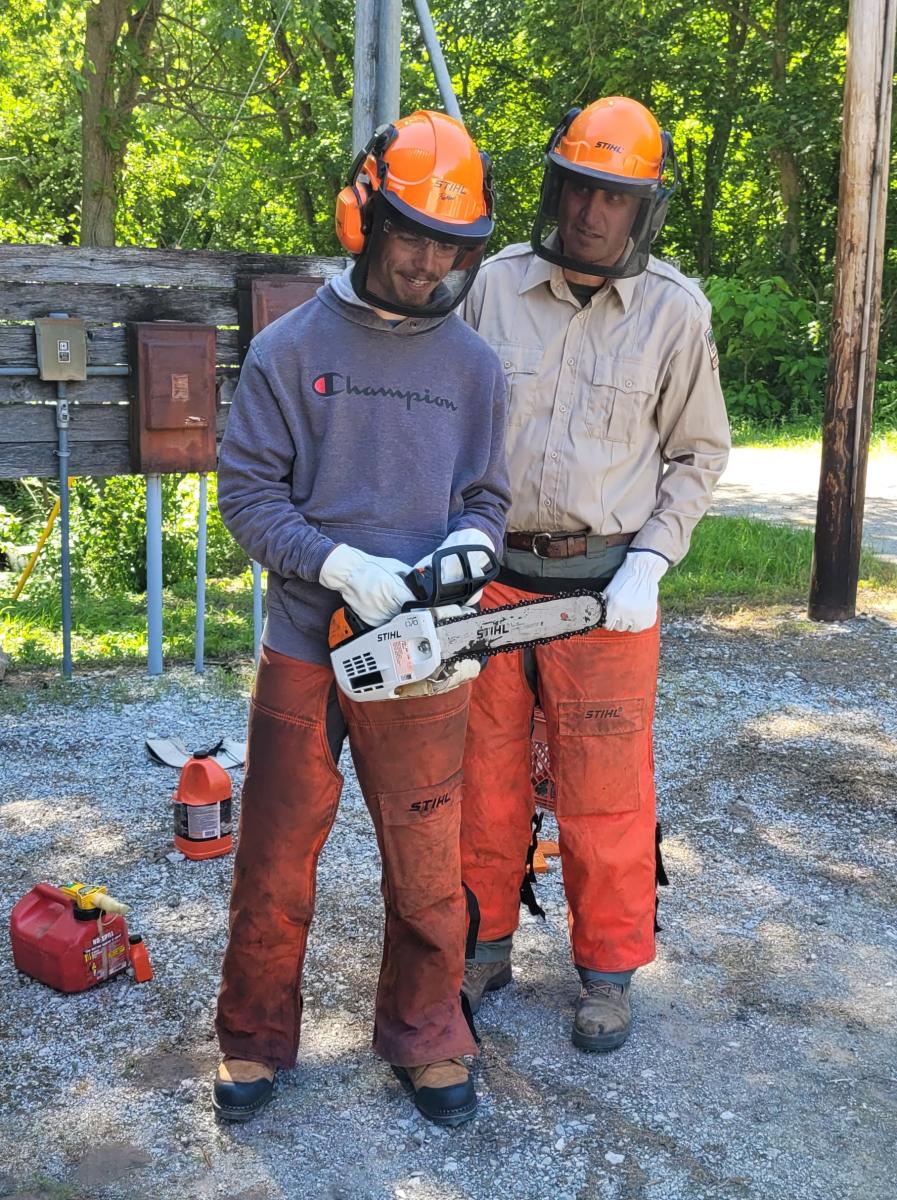 2023-24 Intern River Smart and LaSalle Property Manager Zack DeYoung during a Chainsaw Training for interns.
