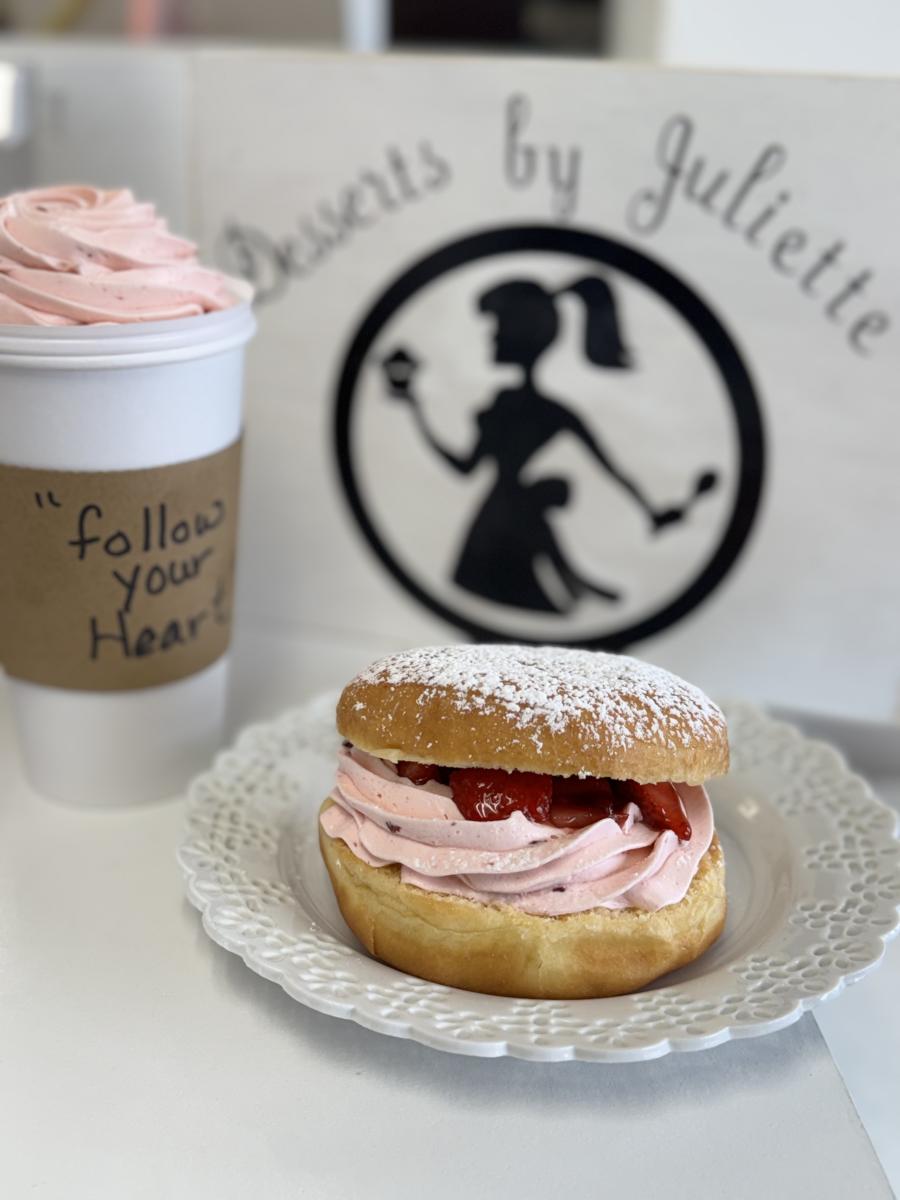 Fresh strawberry cream doughnut dusted with powdered sugar alongside a pink whipped specialty beverage on the Indiana Dunes Coffee & Sweets Trail.
